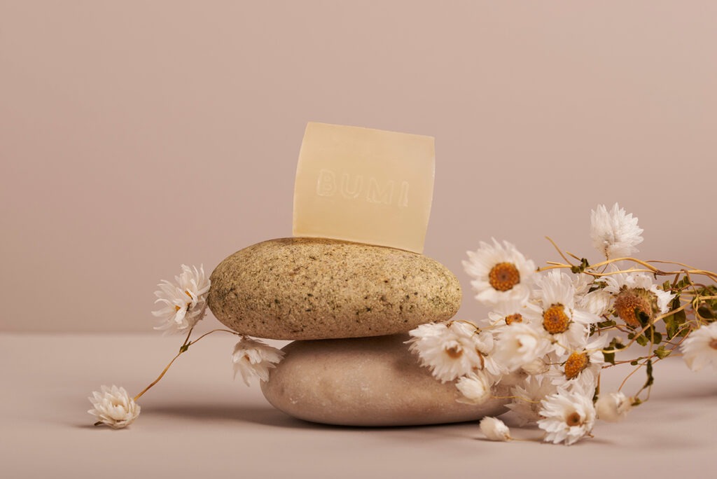 Bumi Bars product photography - natural soap bar with matching colored background and ingredients